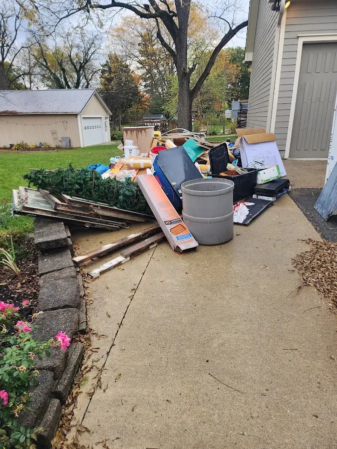 Dumpster being loaded with debris for 3 Yard Dumpster Rental in Milford